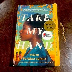 Book called Take My Hand, it’s a signed copy by Dolen Perkins-Valdez